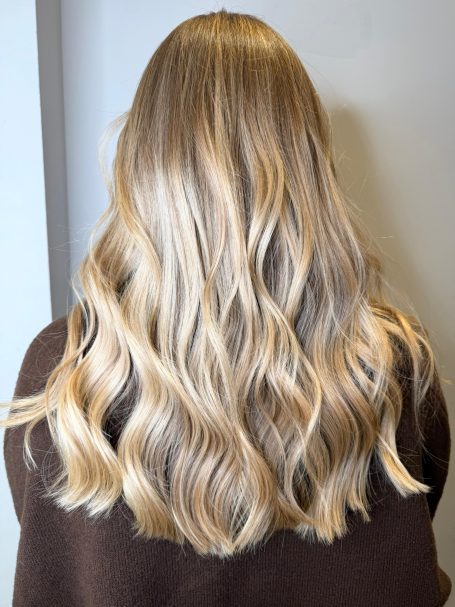 Long, wavy blonde hair viewed from the back.