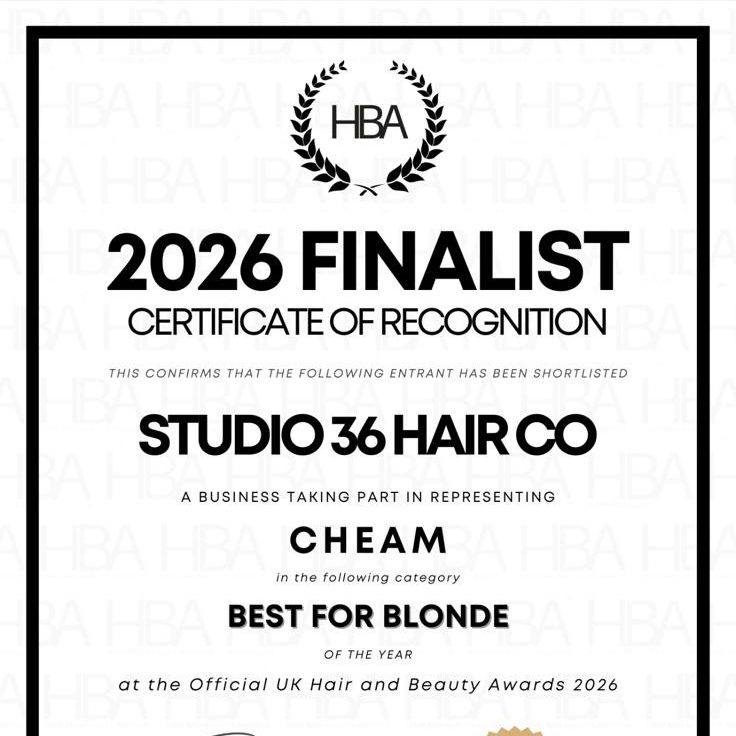 Three women posing with scissors and combs, smiling and showing playful expressions.