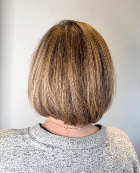 Short bob haircut with straight, light brown hair, viewed from the back.